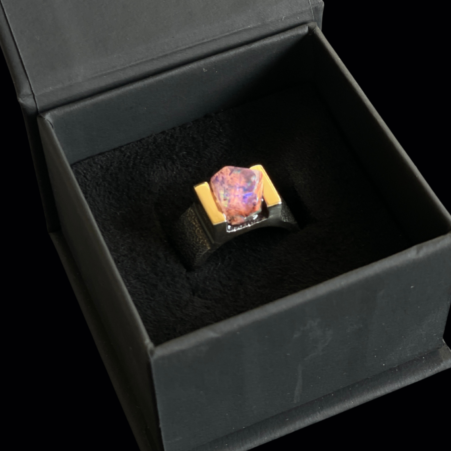 ring with rare mexican opal in a black jewelry box