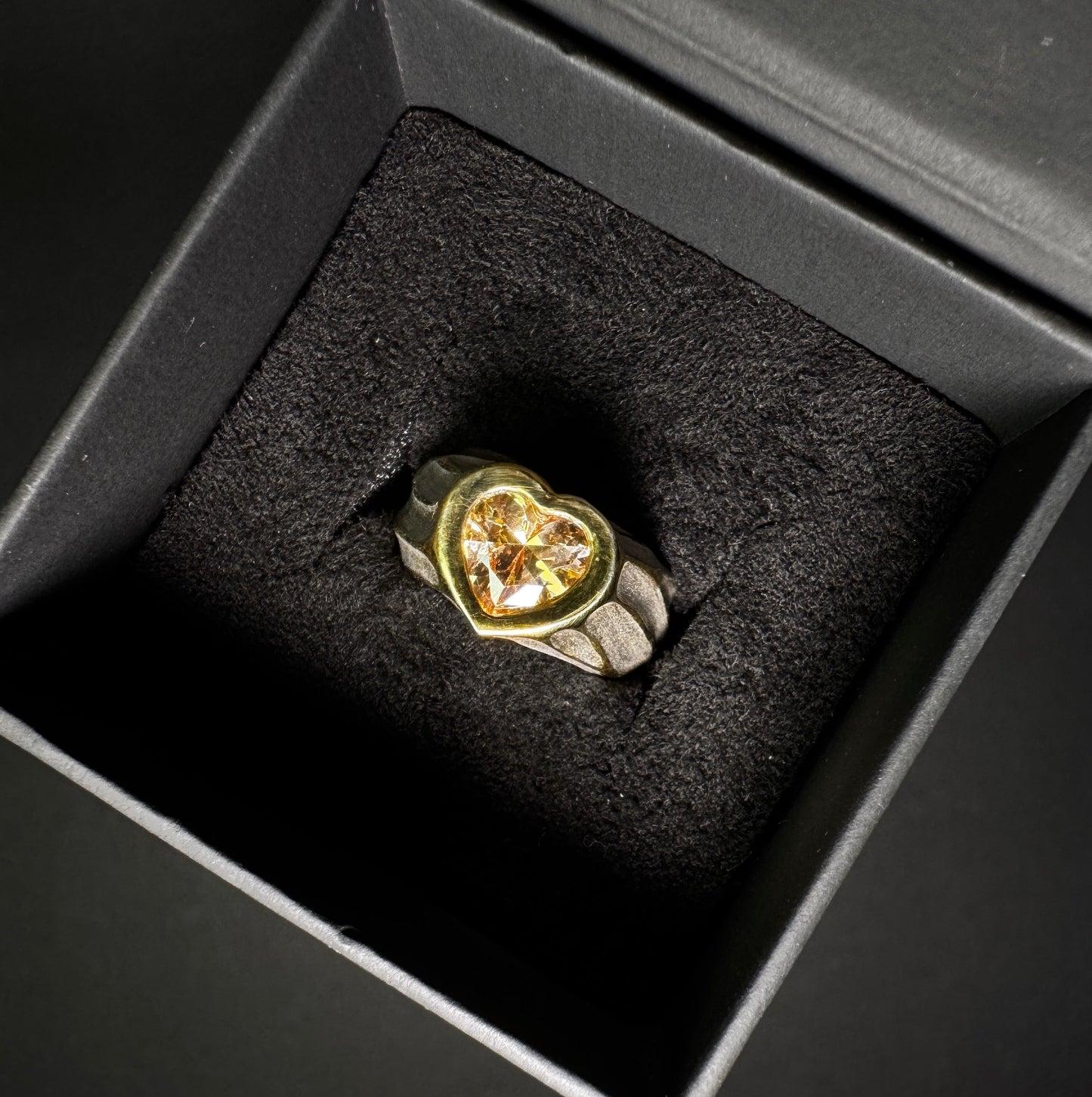 24K Gold plated ring with a heart-shaped gemstone in a black jewelry box