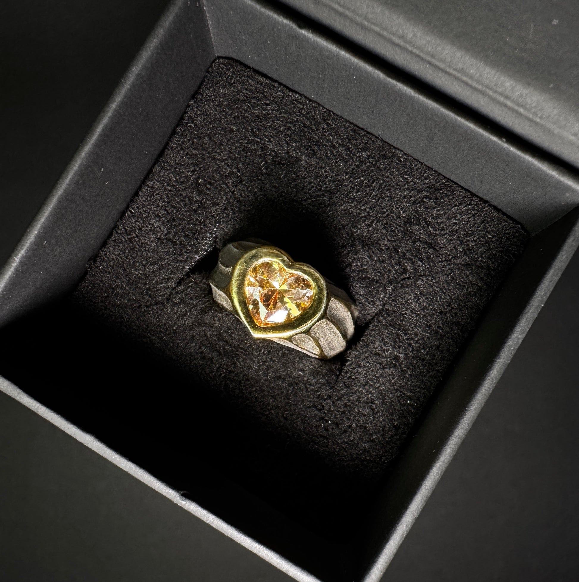 24K Gold plated ring with a heart-shaped gemstone in a black jewelry box
