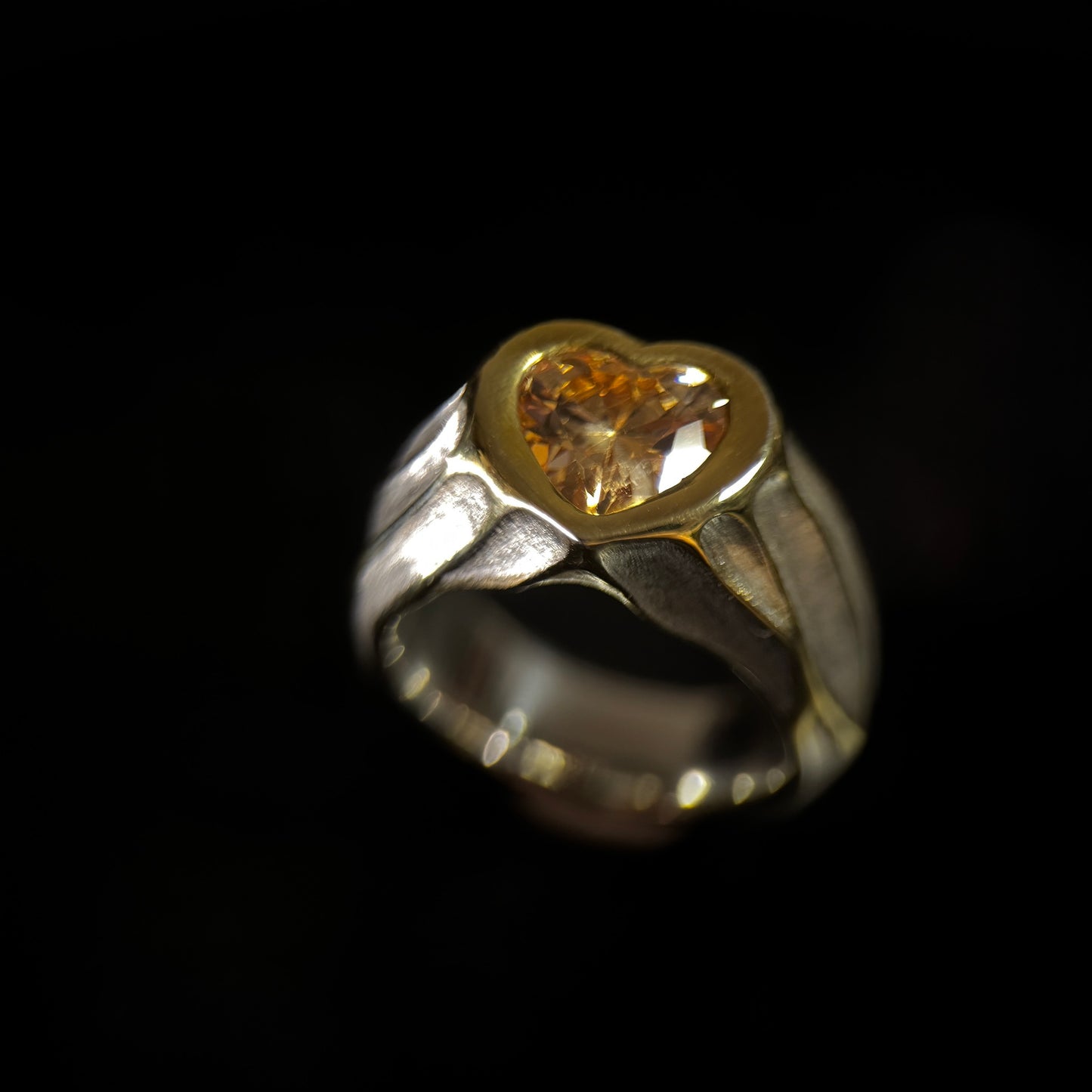 Gold and silver ring with a heart-shaped gemstone