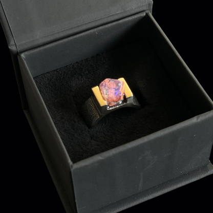 ring with rare mexican opal in a black jewelry box