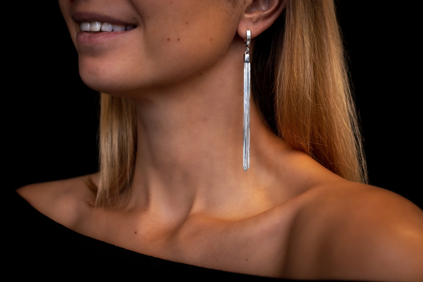 silver dangle drop earrings on woman