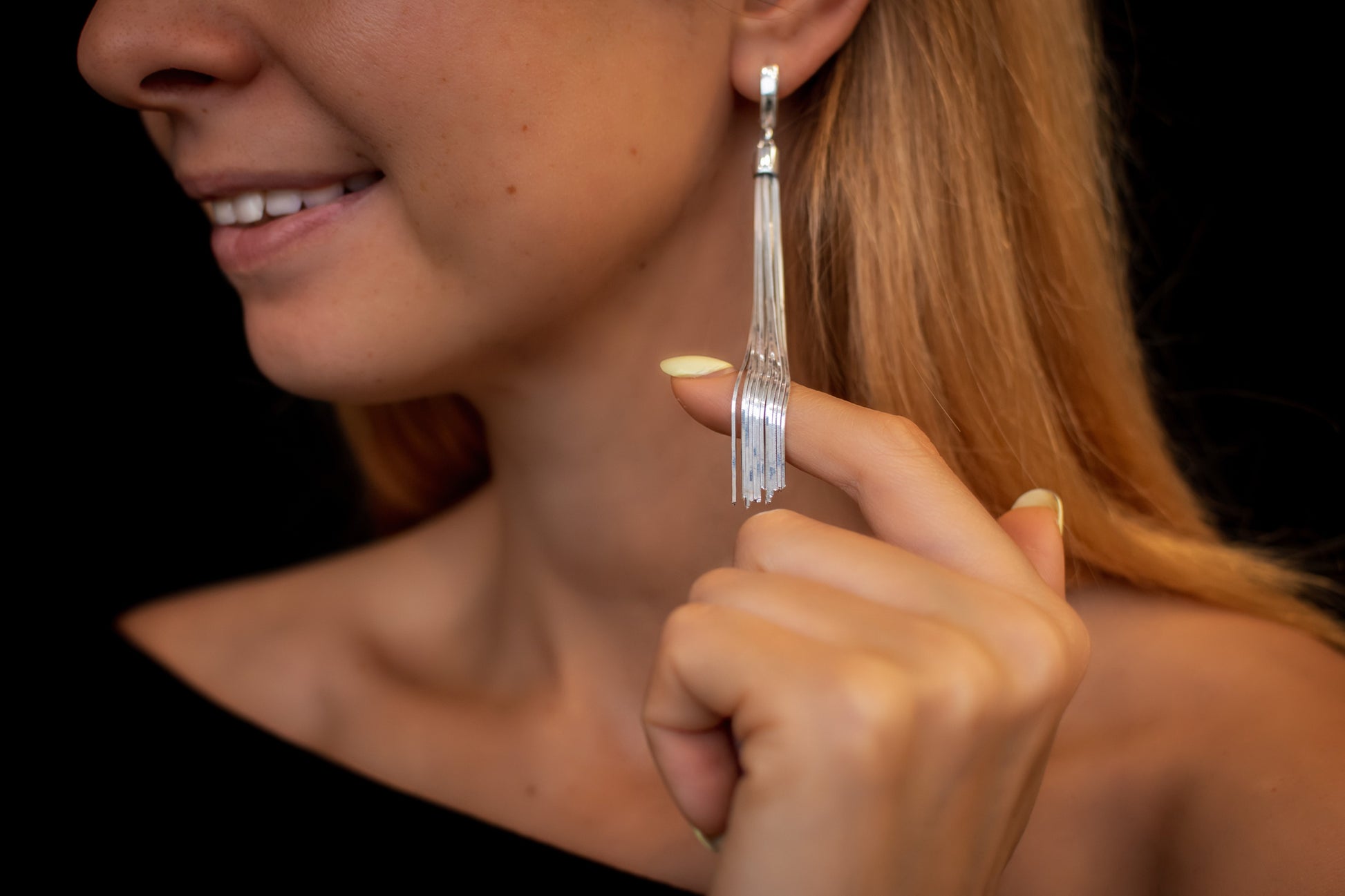 woman wearing silver multi strand earrings 