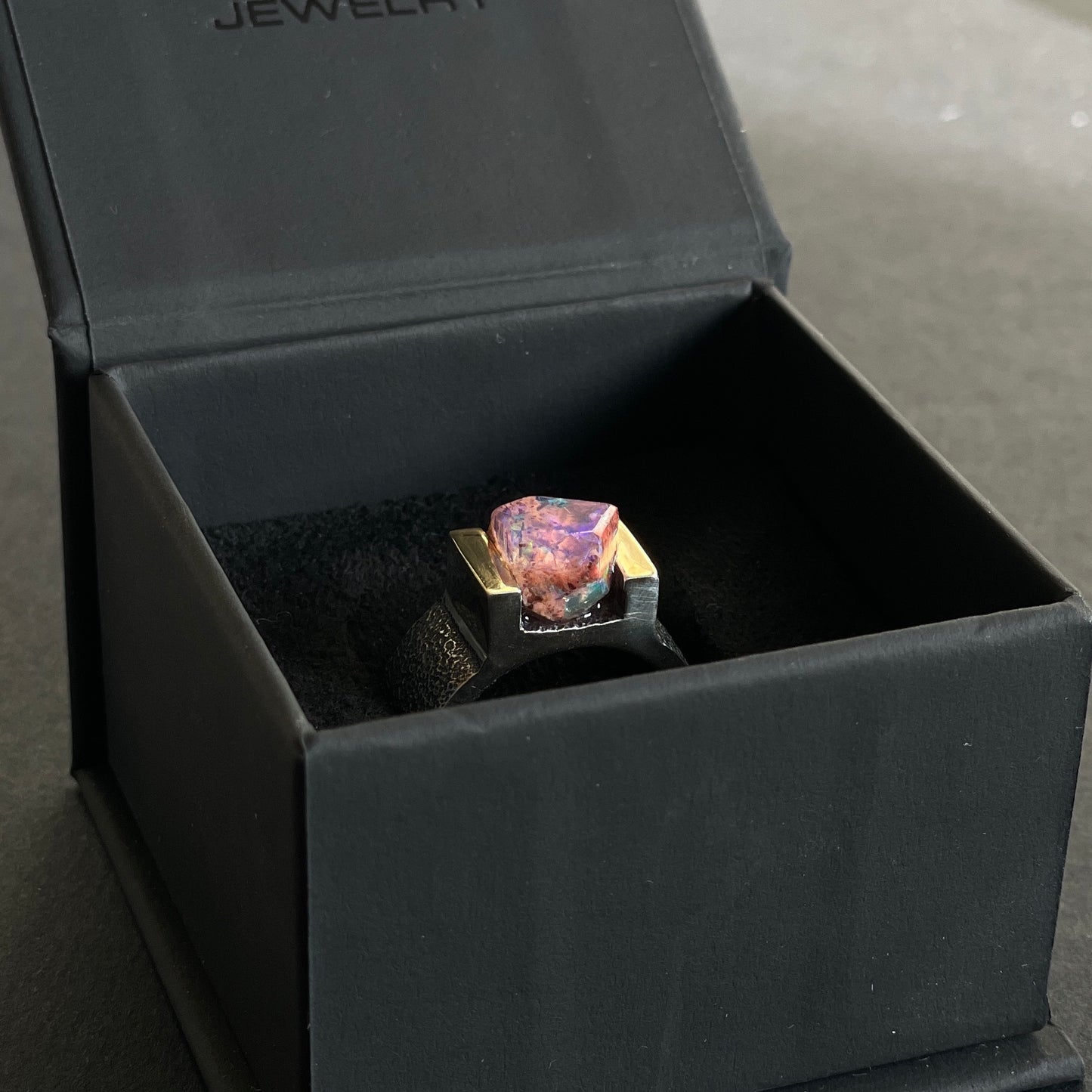 ring with genuine mexican opal in a jewelry box
